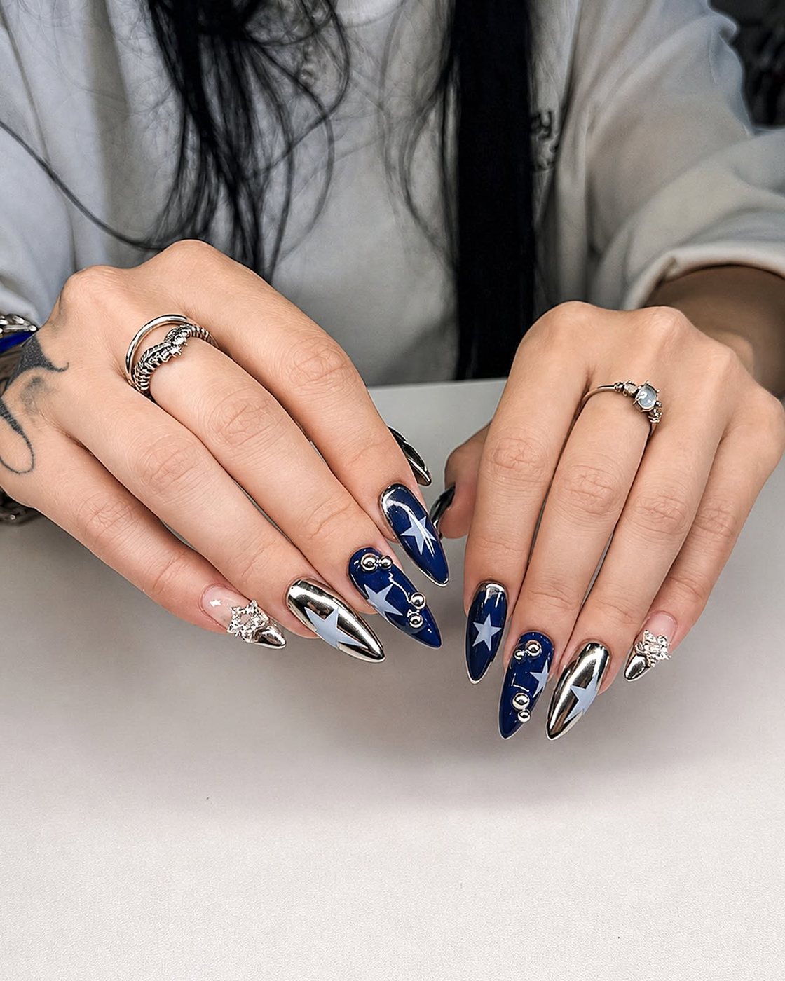 Navy nails with chrome star detailing by My Royal Nails & Spa in Humble, TX