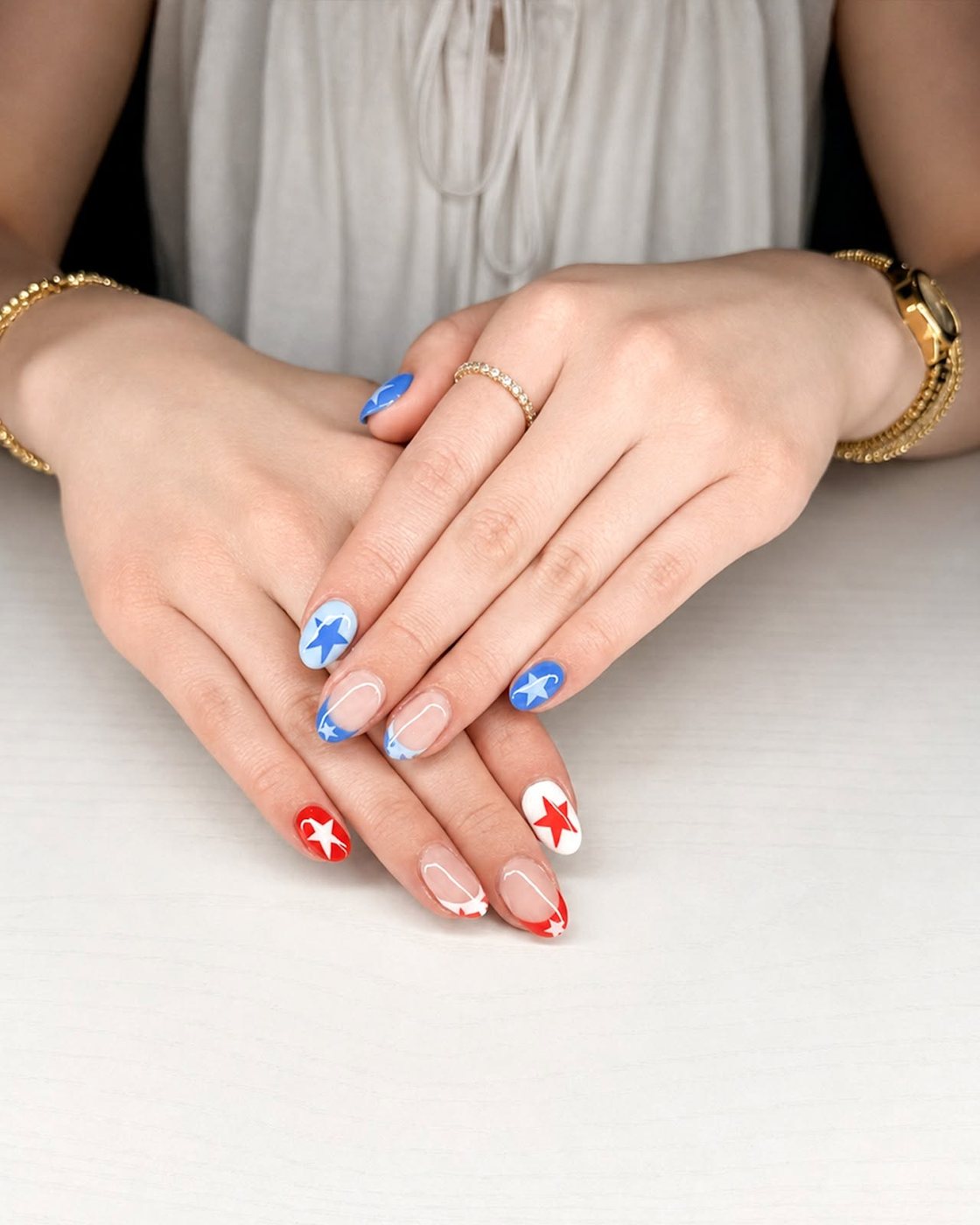 Red and blue French tips with star accents by My Royal Nails & Spa in Humble, TX